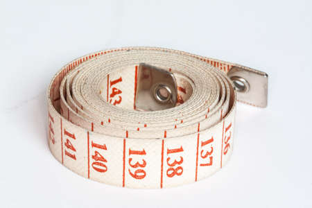 Couturire meter tape wound on white backgroundの写真素材