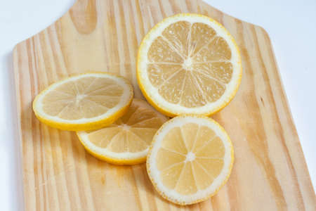 Lemon yellow coup in half and sliced ??on board adcouperの写真素材