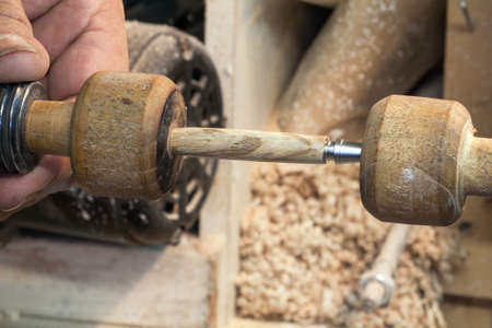 Creation of a pen by turning on a lathe woodの写真素材
