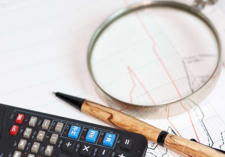 Office equipment, magnifying glass, pen and calculator