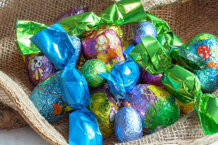 Eggs and chocolate candy on burlap
