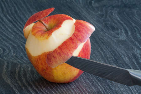 pelee apple and knife on dark backgroundの写真素材