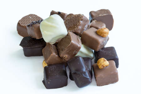 Different bulk chocolate candies on white background