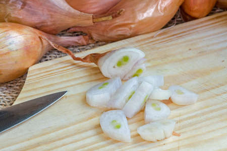 Chopped shallot pieces on cutting boardの写真素材