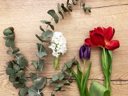 Florist workplace after work. Top view. Making floral decorations. Flowers on a old wooden table. Tools and accessories florists need for making up a bouquet.の写真素材