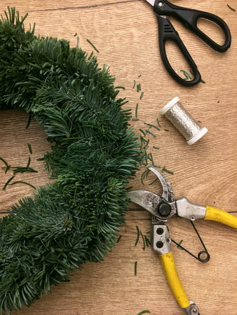 Things to manufacture Christmas wreaths on wooden table.