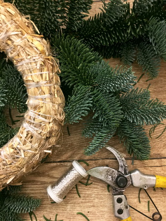 Things to manufacture Christmas wreaths on wooden table.