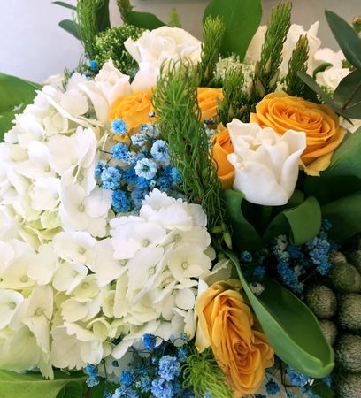 Close-up Beautiful Bouquet. Bouquet of flowers white tulips, white hydrangea, yellow roses blue gypsophila.の写真素材