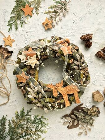 Christmas wreath made of natural materials on a white background. A wreath with beautiful Christmas decorations.の写真素材