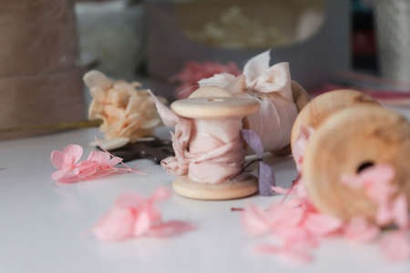 Close-up of flowers Floristic workspace. Details macro flowers. Ribbon silk.