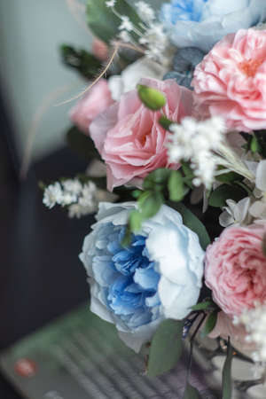 Pink and blue color floral arrangement on white background. Pink and blue roses. Stabilized flowers in a vase. Interior decor.の写真素材