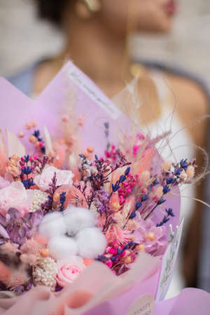 Bouquet dried flower arrangement in pink, yellow and purple. Striking flowers arrangement, comes beautifully wrapped for gift-giving.の写真素材