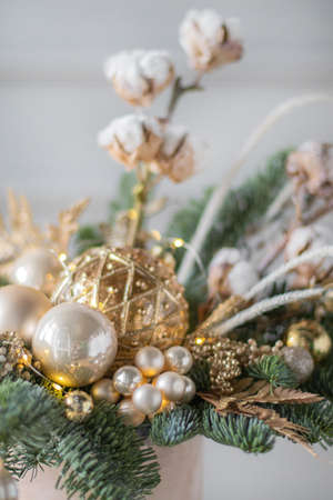 Beautiful winter Christmas floral composition of fresh Nobilis in hat box. Cotton, spruce, sparkling ornaments. Holiday concept. Happy New Year decorations.の写真素材