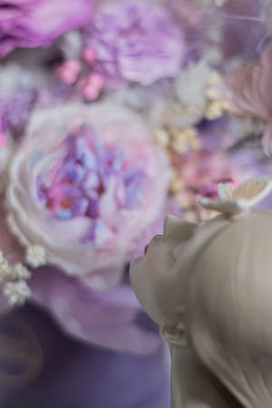 A mix of pink peonies with purple and pink roses on coffee table.の写真素材