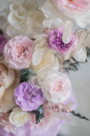 A luxurious bouquet of flowers in a hat box. Composition with pink and white flowers and eucalyptus in a round box. Modern Floristry.の写真素材