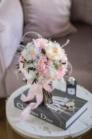 Wedding bouquet of peonies and roses on a table.の写真素材