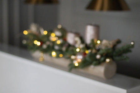 Blurred Christmas decor composition of fir-Tree branches nobilis, cotton flowers, gold balls, toys. Interior decor for the Christmas New Year holidays.の写真素材