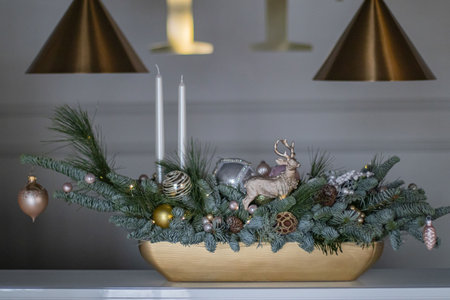 Christmas decoration for home. Christmas decor composition of fir-Tree branches nobilis, christmas balls, toys, gold deer. Interior decor for the Christmas New Year holidays.の写真素材