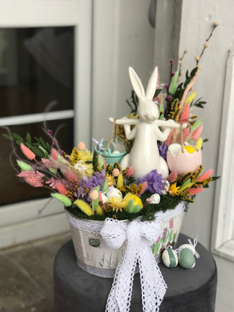 Spring holiday celebration concept. Easter ceramic white Bunny in the flowers.の写真素材