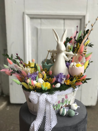 Spring holiday celebration concept. Easter ceramic white Bunny in the flowers.の写真素材