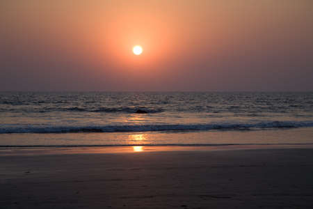 Sunset on the beach in north Goa near the oceanの写真素材