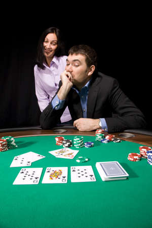 Couple in the casino playing poker on green feltのeditorial素材