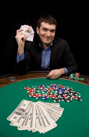 Royal flush in poker hand win on table with green feltのeditorial素材