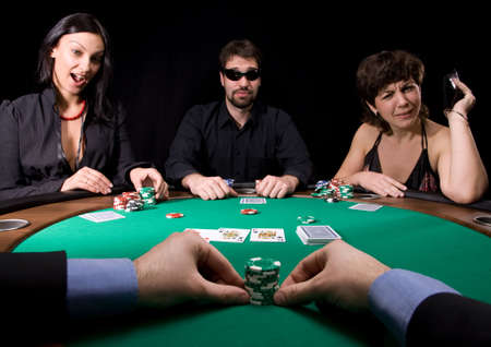 Company of friends having fun in the casino poker tableのeditorial素材