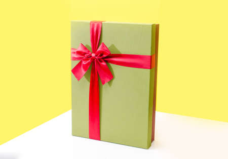 gift box close up isolated on yellow backgroundの写真素材