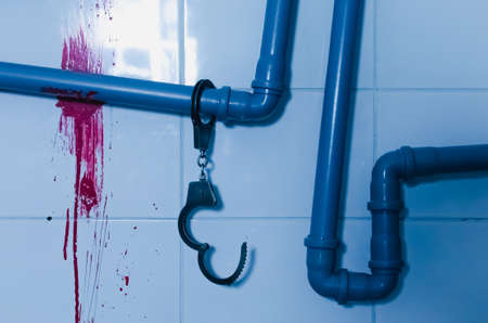 Iron handcuff on bloody wall horror