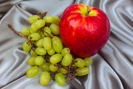 Red apple and light grapes.の写真素材
