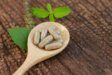 Herbal supplement with herb on wooden table for healthy eatingの写真素材