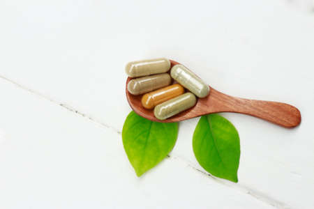 Herbal supplement on wooden spoon for healthy eatingの写真素材