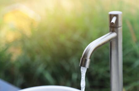 pouring water from faucet for using at homeの写真素材
