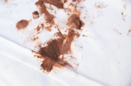 dirty choclate stain on kid shirt from eating for cleaning concept in housework clear. selective focus.の写真素材