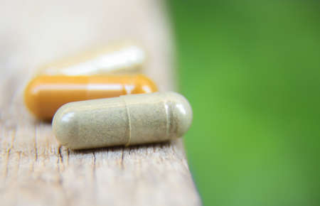 close up photo of herbal capsule from organic herb for health care using. alternative multivitamins...