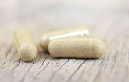 close up photo of herbal capsule from organic herb for health care using. alternative multivitamins...