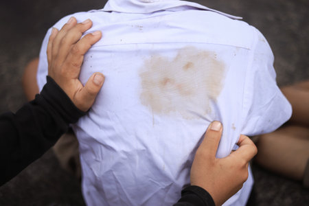 dirty stain on kis shirt at back from playing hard in daily life for cleaning concept. selective focus.の写真素材