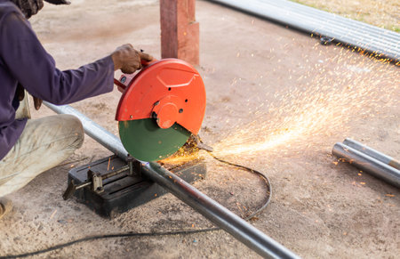 man using metal cutting blade machine in outdoor work activity. selective focus.の写真素材