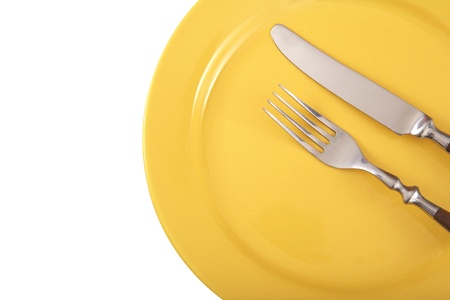 Cutlery and yellow plate の写真素材