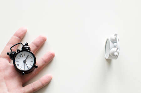 Alarm clock friends situation with handの写真素材