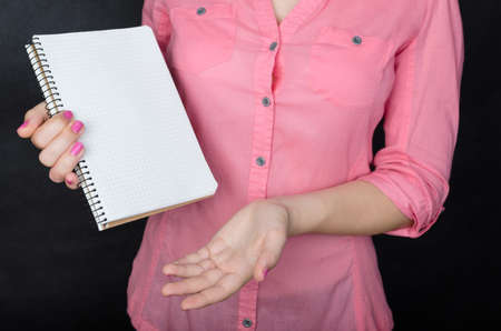 Young woman in pink shirt workingの写真素材