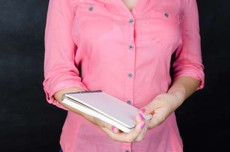 Young woman in pink shirt working