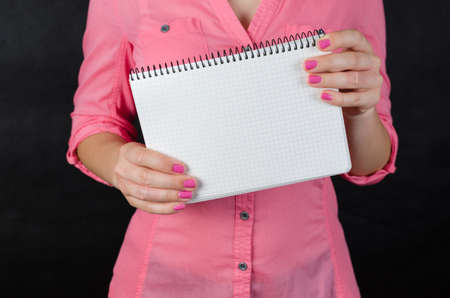 Young woman in pink shirt workingの写真素材