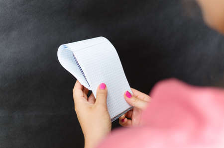 Young woman in pink shirt working