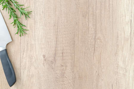 Herbs with knife on wooden tableの写真素材