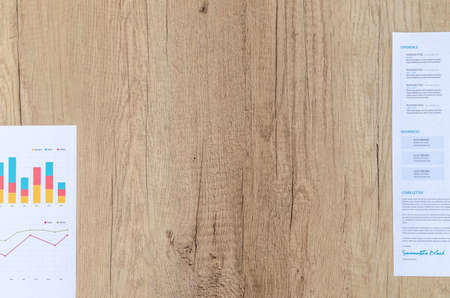 Workplace on wooden table with graph papersの写真素材