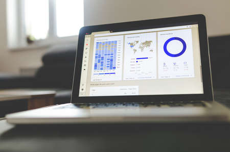 Notebook work with statistics on sofa businessの写真素材