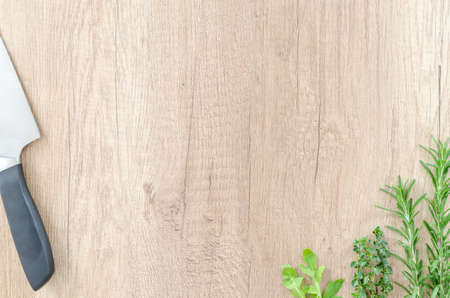 Herbs with knife on wooden tableの写真素材
