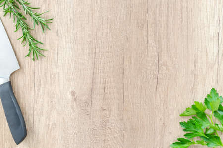 Herbs with knife on wooden tableの写真素材